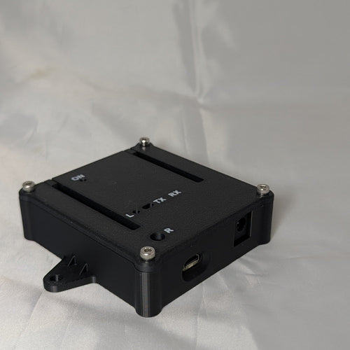 Black electronics enclosure with white text for status LED ports on a white background