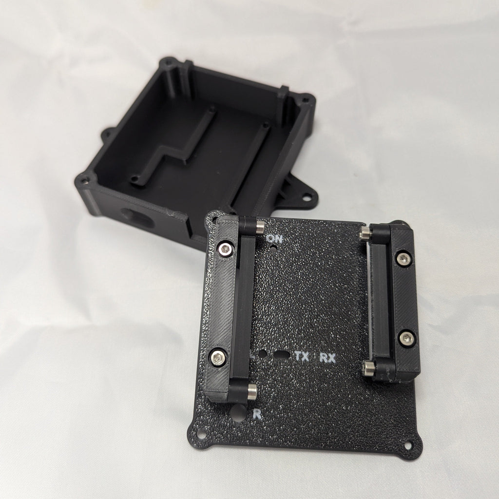 Black electronic enclosure with labeled status LED ports on a white background
