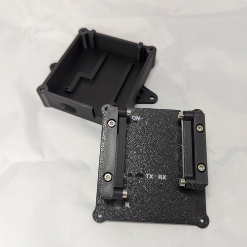 Black electronic enclosure with labeled status LED ports on a white background